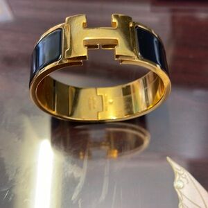 Women’s   black  and gold authentic Hermes bracelet